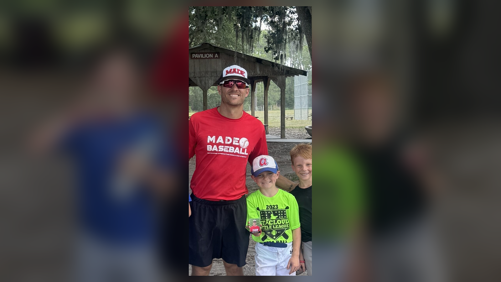 Coach Isaac Hess with two youth baseball players at a MADE Baseball field session