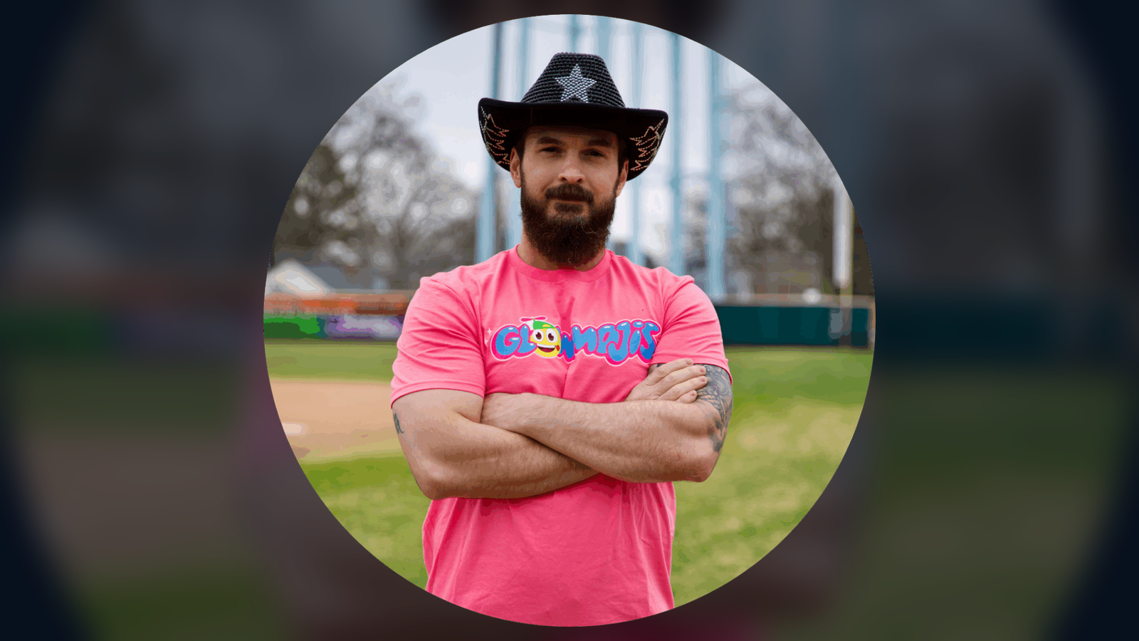 Ray Ortega wearing a Glowmojis shirt and cowboy hat on a baseball field