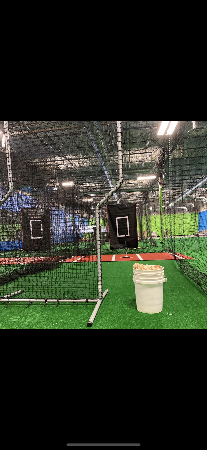 5 indoor batting cages with an open practice space