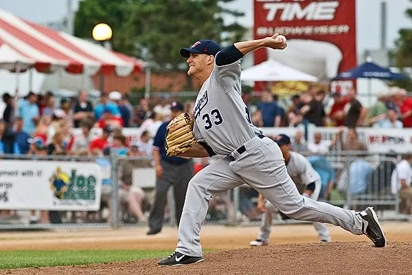 Isaac Hess pitching professionally in Winnipeg, wearing number 33