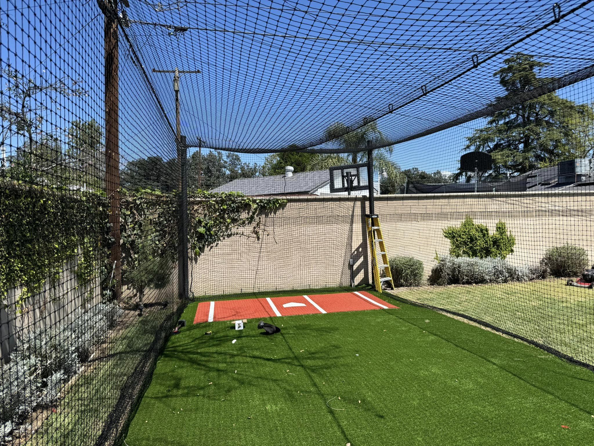 Coach running a practice in a batting cage facility